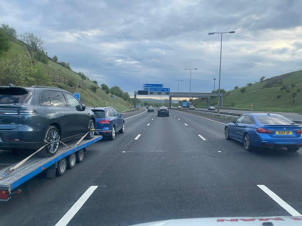 Breakdown Man's recovery truck heading up the motorway with a long-haul tow.