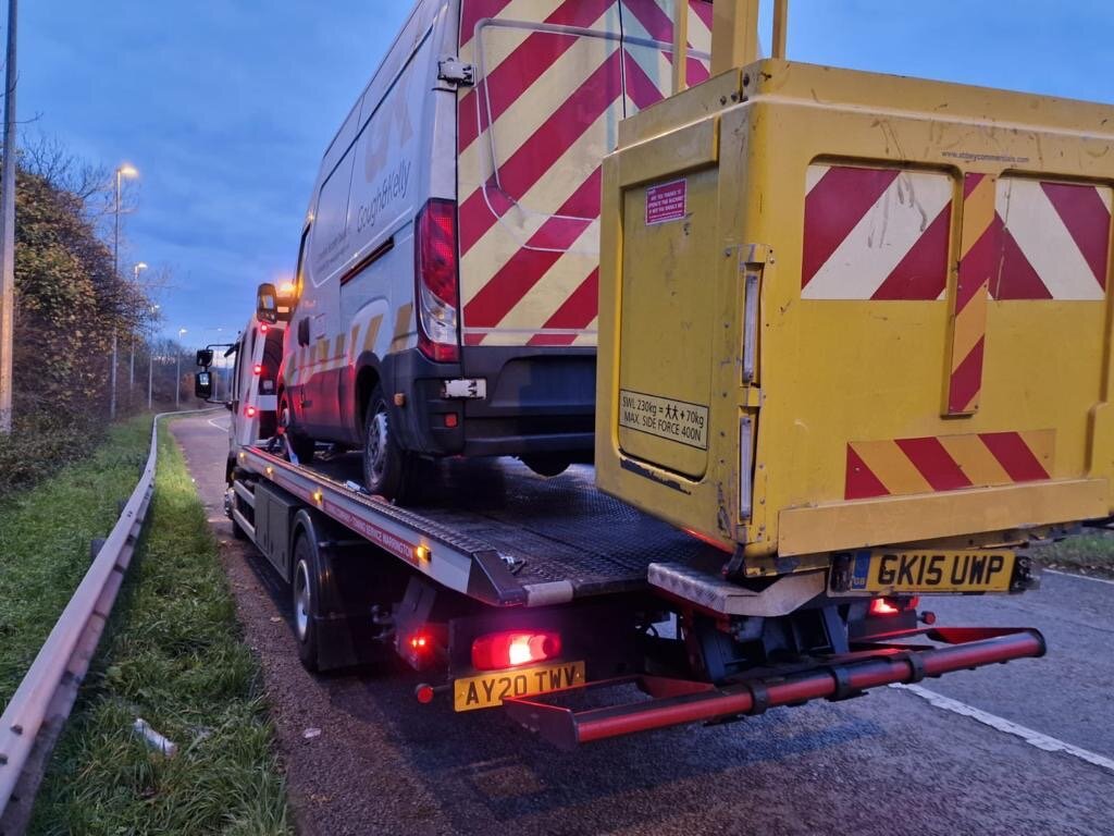 Cough & Kelly cherry-picker Iveco van AY20 TWV loaded on Breakdown Man's flatbed at dawn.
