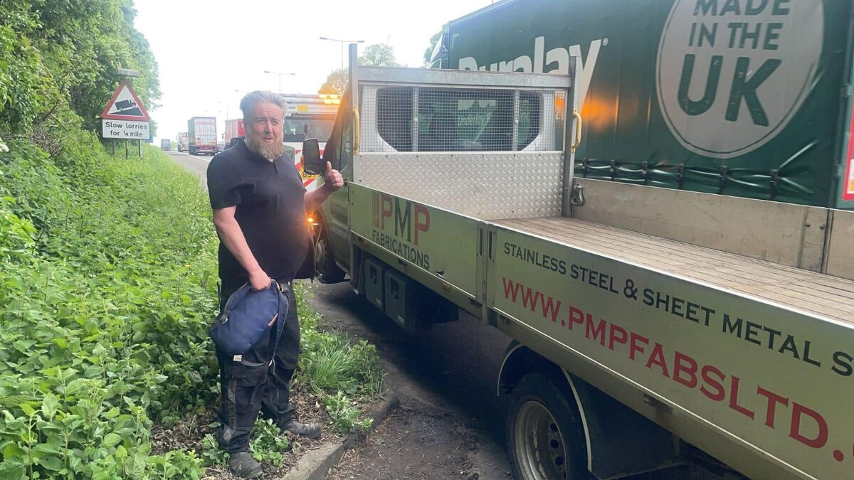 Simon at the roadside with a PMP Fabrications stainless steel flatbed truck on a slow-lorry lay-by.